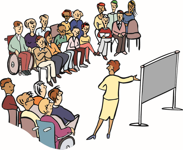 Gruppe von Menschen hört einen Vortrag von einer Frau, die vor einer Tafel steht.