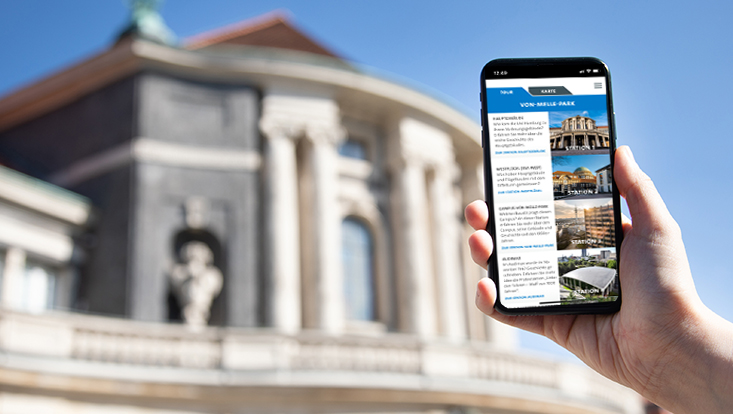 Handy zeigt die mobile Ansicht der Campus-Tour vor dem Hauptgebäude der Uni Hamburg
